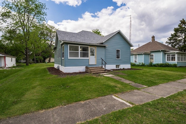 303 S Main St, Flanagan, IL 61740 - view of front of home featuring a shingled roof, a front yard, and entry steps