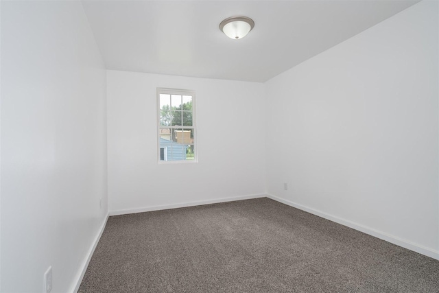 303 S Main St, Flanagan, IL 61740 - empty room featuring dark carpet and baseboards