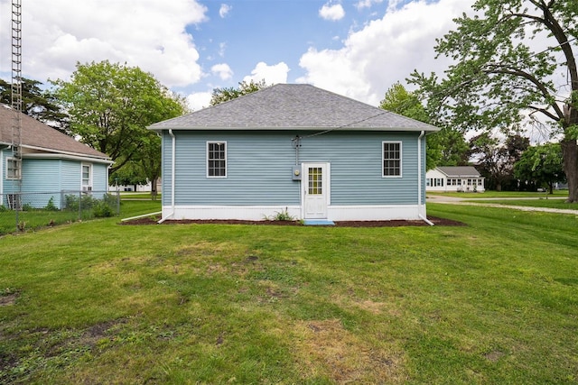 303 S Main St, Flanagan, IL 61740 - rear view of property featuring a lawn and a shingled roof