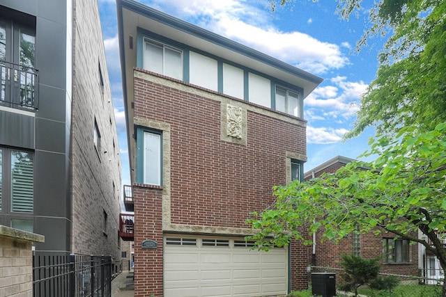 1512 W Diversey Pkwy Unit B, Chicago, IL 60614 - rear view of house with brick siding, an attached garage, fence, and cooling unit