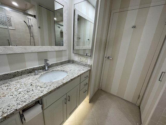 full bath featuring a shower stall, vanity, and tile patterned floors