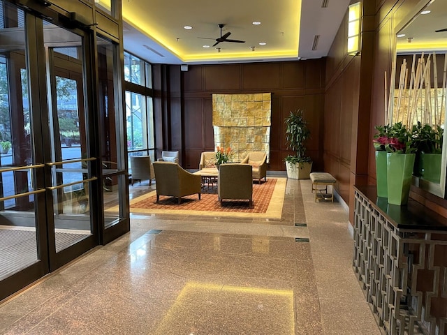 community lobby featuring a decorative wall, a towering ceiling, and recessed lighting