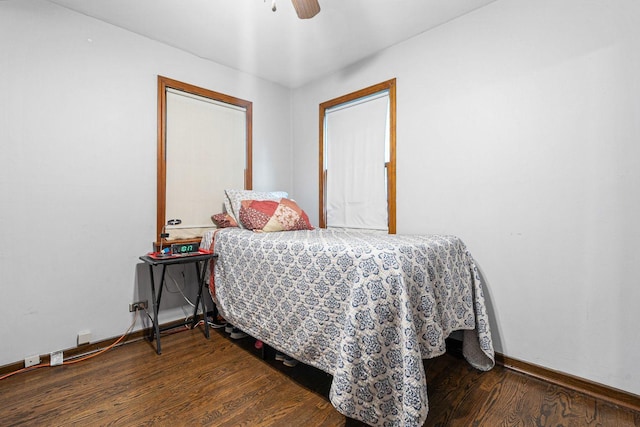 bedroom featuring wood finished floors, baseboards, and ceiling fan