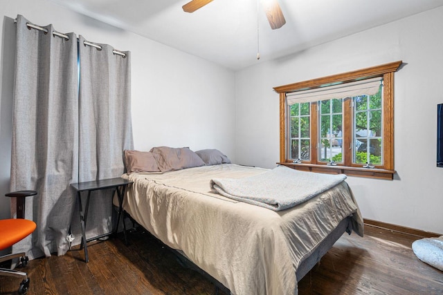 bedroom featuring dark wood-style flooring, baseboards, and ceiling fan