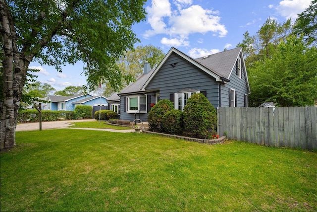 view of front of property with a chimney and a shingled roof