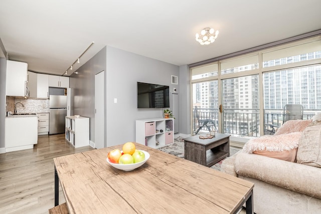 21 W Chestnut St Unit 907, Chicago, IL 60610 - living area with light wood-style flooring and rail lighting