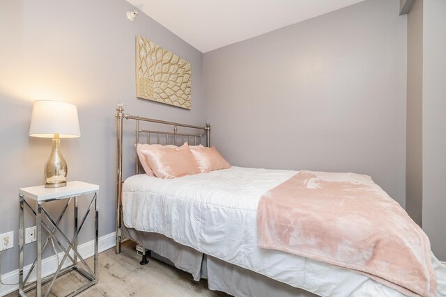 21 W Chestnut St Unit 907, Chicago, IL 60610 - bedroom with wood finished floors, baseboards, and vaulted ceiling