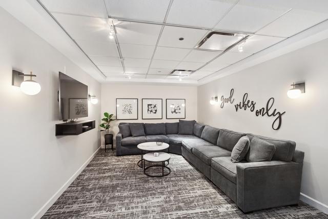 30 E Huron St Unit 2708, Chicago, IL 60611 - living area with baseboards, carpet floors, and track lighting