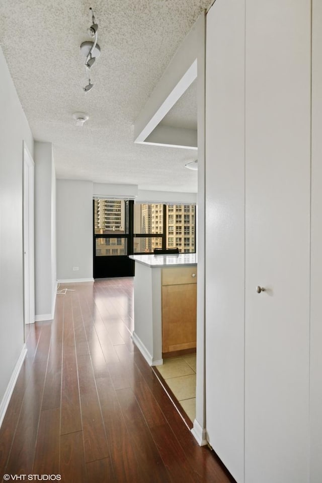 30 E Huron St Unit 2708, Chicago, IL 60611 - hallway featuring a textured ceiling, wood finished floors, and baseboards