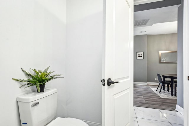 1806 S Trumbull Ave, Chicago, IL 60623 - bathroom with marble look tiles, toilet, and baseboards