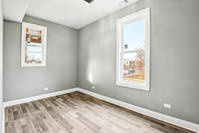 1806 S Trumbull Ave, Chicago, IL 60623 - empty room with healthy amount of natural light, baseboards, and wood finished floors