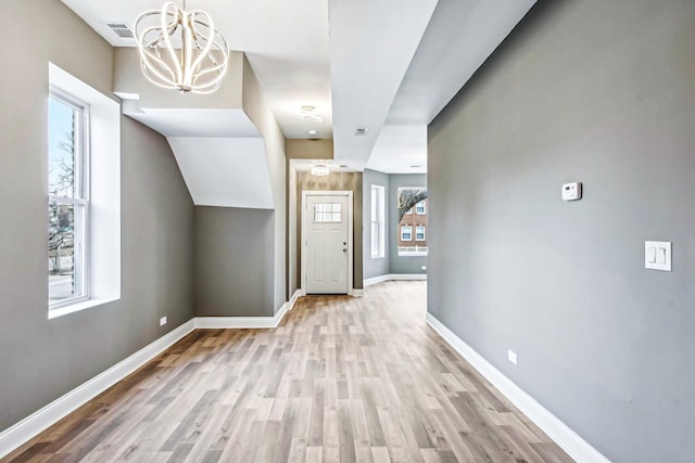 1806 S Trumbull Ave, Chicago, IL 60623 - hall featuring a chandelier, baseboards, and light wood finished floors