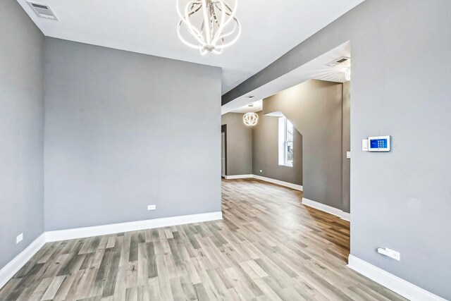 1806 S Trumbull Ave, Chicago, IL 60623 - empty room with baseboards, wood finished floors, and a chandelier