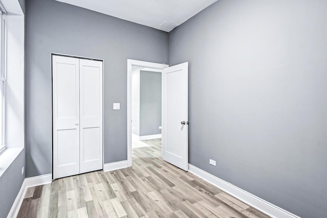 1806 S Trumbull Ave, Chicago, IL 60623 - unfurnished bedroom featuring light wood-style floors, a closet, and baseboards