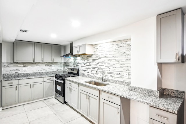 1806 S Trumbull Ave, Chicago, IL 60623 - kitchen with gas range, a sink, wall chimney range hood, and gray cabinets