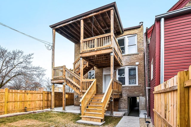 1806 S Trumbull Ave, Chicago, IL 60623 - rear view of property featuring stairway, a fenced backyard, brick siding, and a balcony