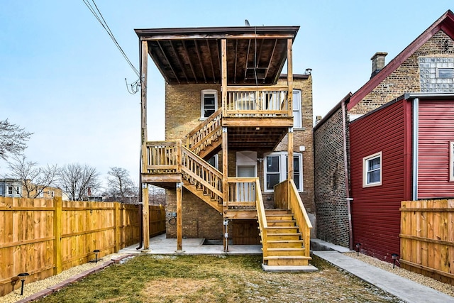 1806 S Trumbull Ave, Chicago, IL 60623 - rear view of property featuring stairway, brick siding, a patio, and a wooden deck