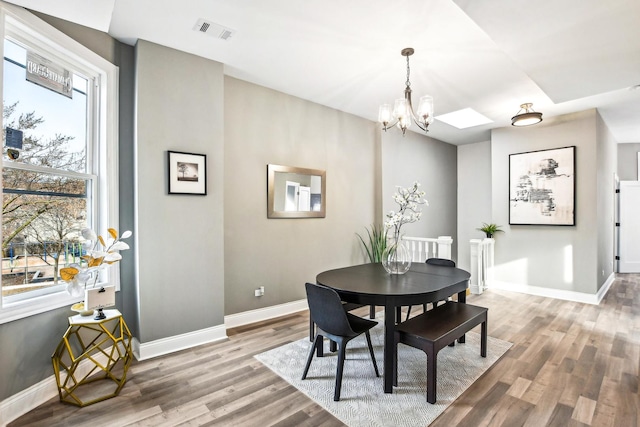 1806 S Trumbull Ave, Chicago, IL 60623 - dining area featuring wood finished floors, baseboards, and a chandelier