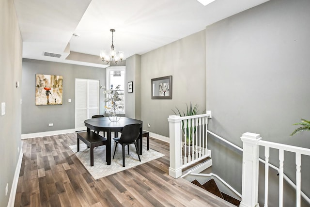 1806 S Trumbull Ave, Chicago, IL 60623 - dining area featuring wood finished floors, a chandelier, and baseboards