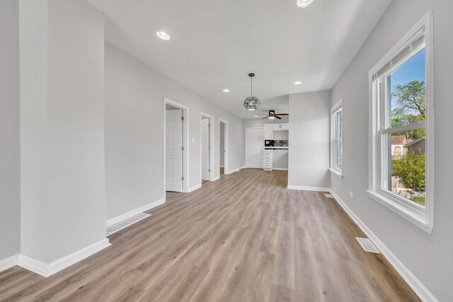 14631 Vincennes Rd, Harvey, IL 60426 - unfurnished living room featuring light wood-style flooring, baseboards, recessed lighting, and a ceiling fan