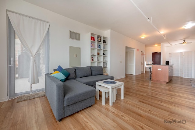 437 W Division St Unit 505, Chicago, IL 60610 - living room featuring light wood finished floors, a ceiling fan, baseboards, and built in features