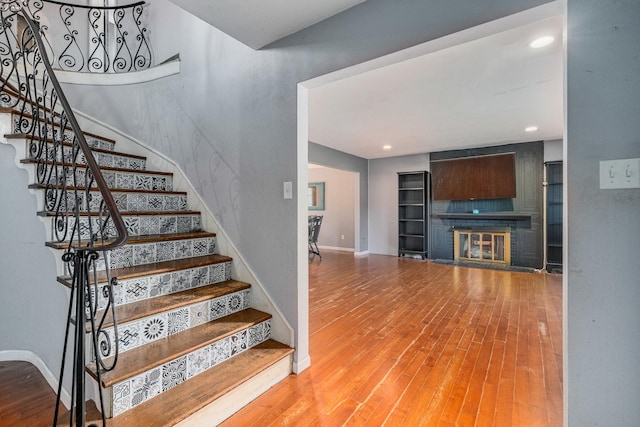 22614 S Joseph Ave, Channahon, IL 60410 - stairs with wood finished floors, a glass covered fireplace, and recessed lighting
