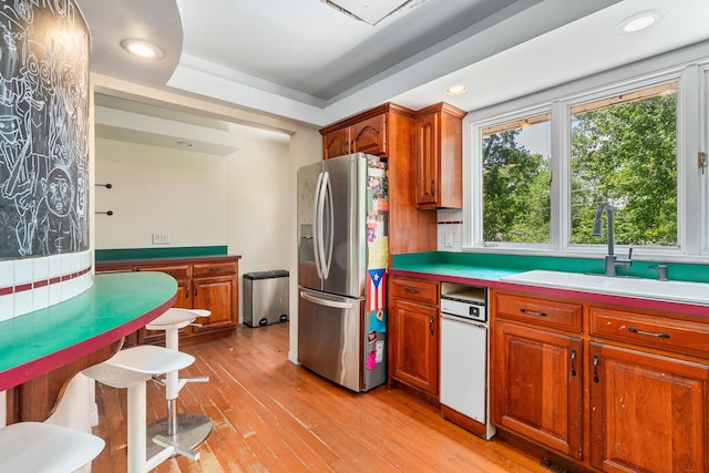 22614 S Joseph Ave, Channahon, IL 60410 - kitchen with stainless steel fridge with ice dispenser, light wood-style floors, brown cabinets, light countertops, and recessed lighting
