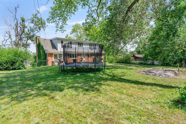 22614 S Joseph Ave, Channahon, IL 60410 - rear view of property featuring a trampoline, a chimney, and brick siding