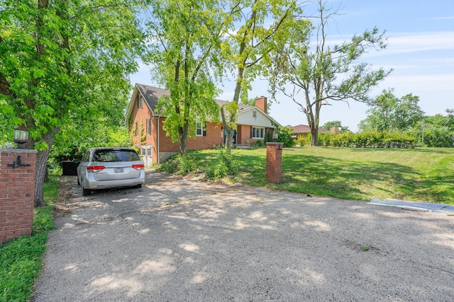 22614 S Joseph Ave, Channahon, IL 60410 - view of front of house featuring a front lawn, brick siding, and a chimney