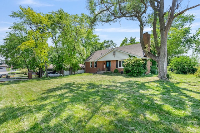 22614 S Joseph Ave, Channahon, IL 60410 - view of front of house with brick siding, a front lawn, and a chimney