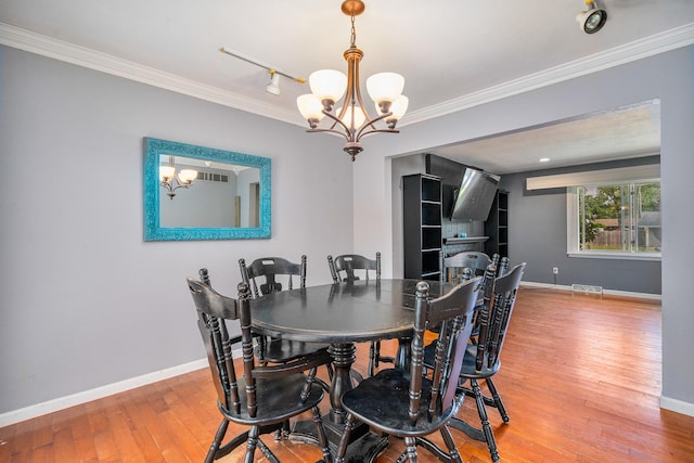 22614 S Joseph Ave, Channahon, IL 60410 - dining area with a chandelier, hardwood / wood-style flooring, ornamental molding, and track lighting