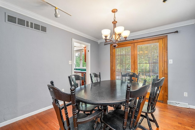 22614 S Joseph Ave, Channahon, IL 60410 - dining space with a chandelier, light wood finished floors, crown molding, and french doors