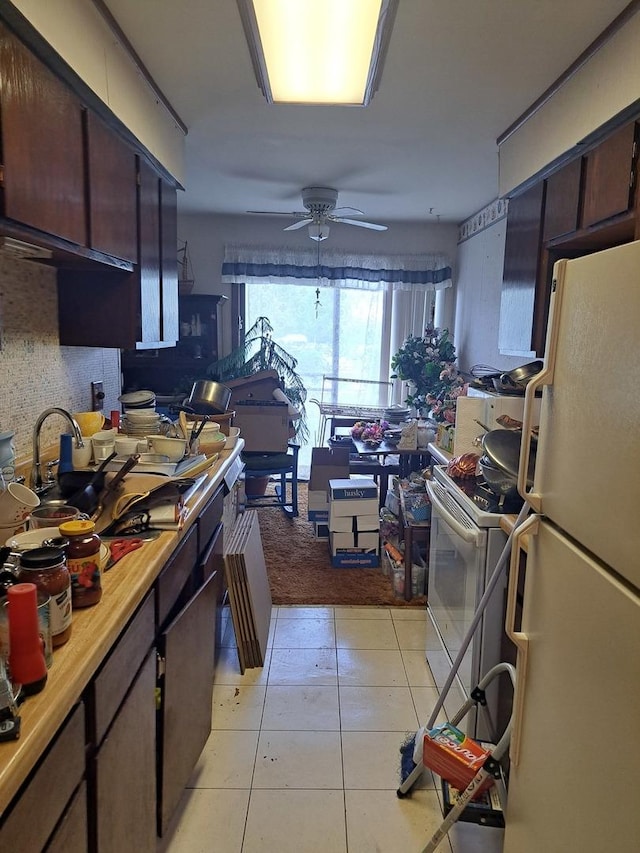 1400 N Elmhurst Rd Unit 106, Mount Prospect, IL 60056 - kitchen with white appliances, light tile patterned floors, a ceiling fan, light countertops, and a sink