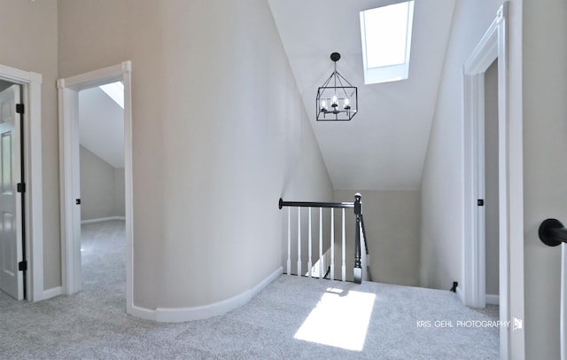 1401 N Park Dr, Round Lake Beach, IL 60073 - stairway featuring carpet, vaulted ceiling, a chandelier, a skylight, and baseboards