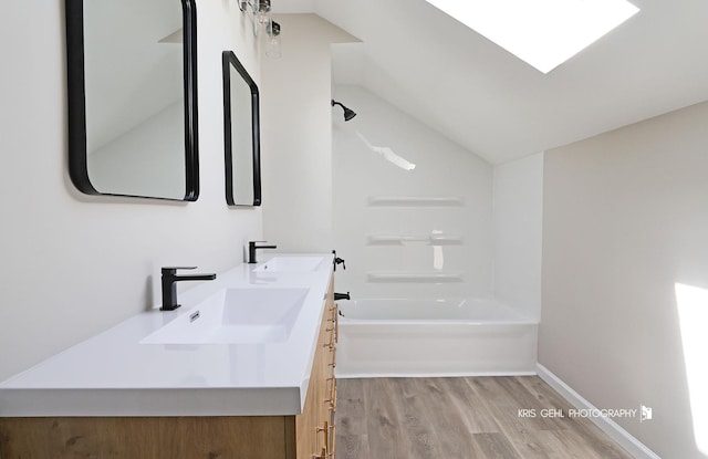 1401 N Park Dr, Round Lake Beach, IL 60073 - full bathroom with wood finished floors, shower / bathtub combination, vaulted ceiling, and double vanity