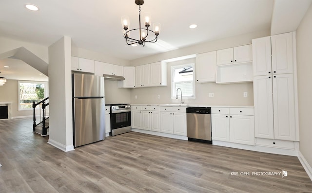 1401 N Park Dr, Round Lake Beach, IL 60073 - kitchen with stainless steel appliances, a chandelier, recessed lighting, light wood finished floors, and under cabinet range hood