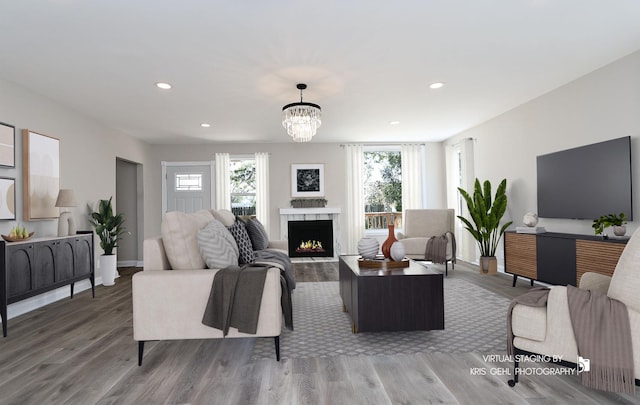 1401 N Park Dr, Round Lake Beach, IL 60073 - living area with wood finished floors, a lit fireplace, recessed lighting, a chandelier, and baseboards