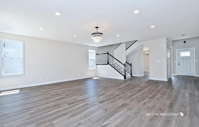1401 N Park Dr, Round Lake Beach, IL 60073 - unfurnished living room featuring a chandelier, stairs, recessed lighting, light wood-style flooring, and baseboards