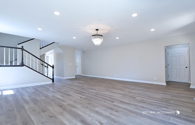 1401 N Park Dr, Round Lake Beach, IL 60073 - unfurnished living room with recessed lighting, a chandelier, stairs, wood finished floors, and baseboards