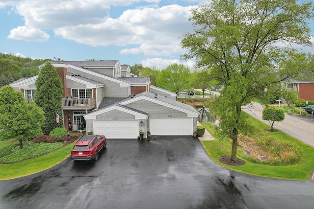 8421 Canary Grass Ln Unit 8421, Fox Lake, IL 60020 - view of front of home featuring asphalt driveway, an attached garage, and a balcony