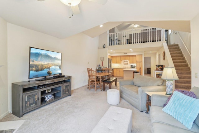 8421 Canary Grass Ln Unit 8421, Fox Lake, IL 60020 - living area with a ceiling fan, a towering ceiling, light colored carpet, and stairway