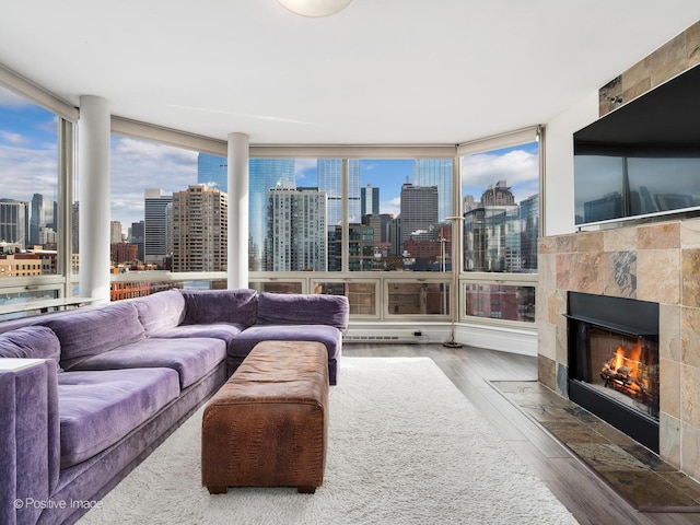 720 W Randolph St Unit 907, Chicago, IL 60661 - living room with wood finished floors, plenty of natural light, a wall of windows, and a tile fireplace