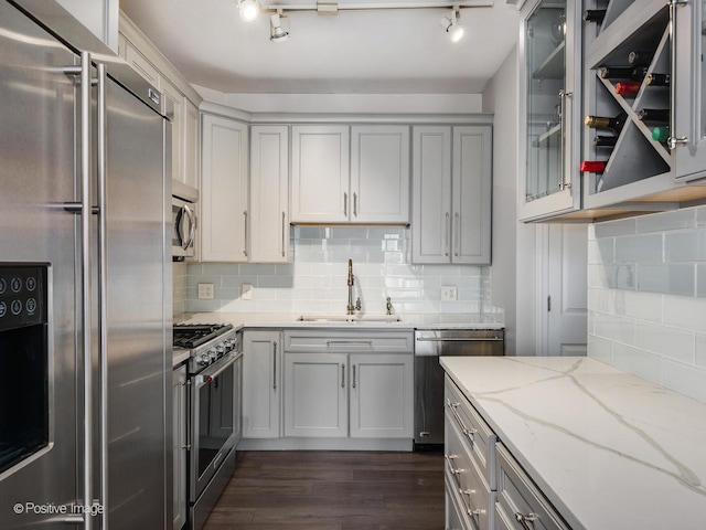 720 W Randolph St Unit 907, Chicago, IL 60661 - kitchen with high quality appliances, a sink, gray cabinets, dark wood finished floors, and tasteful backsplash