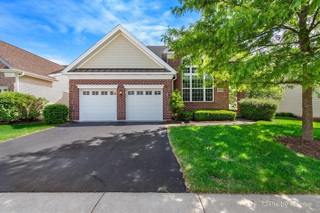 3879 Seigle Dr, Elgin, IL 60124 - traditional home with asphalt driveway, a garage, brick siding, and a front lawn
