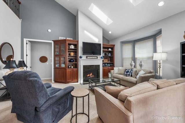 3879 Seigle Dr, Elgin, IL 60124 - living room with a skylight, high vaulted ceiling, a high end fireplace, light colored carpet, and recessed lighting