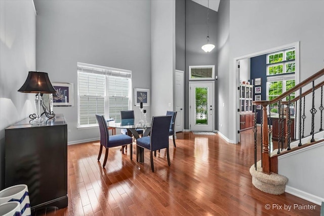 3879 Seigle Dr, Elgin, IL 60124 - dining space with a high ceiling, stairs, baseboards, and wood-type flooring