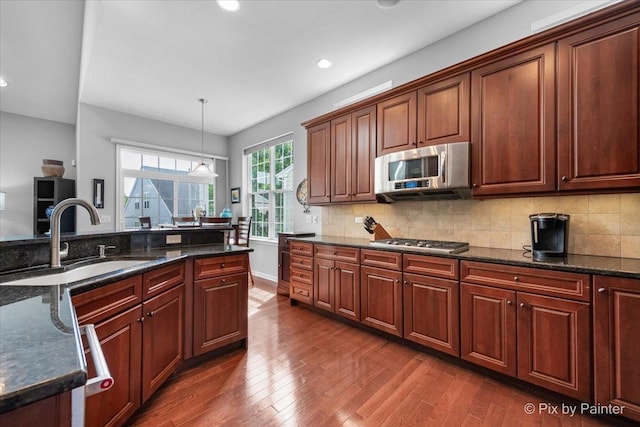 3879 Seigle Dr, Elgin, IL 60124 - kitchen featuring stainless steel appliances, a sink, dark wood-style flooring, recessed lighting, and tasteful backsplash