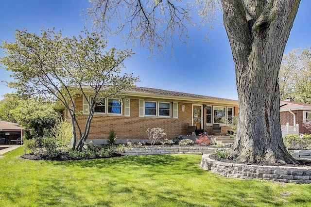ranch-style home with brick siding and a front yard