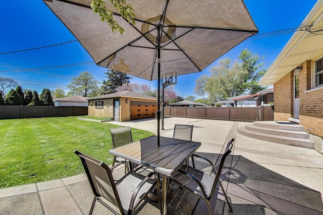 view of patio featuring outdoor dining area and an outbuilding