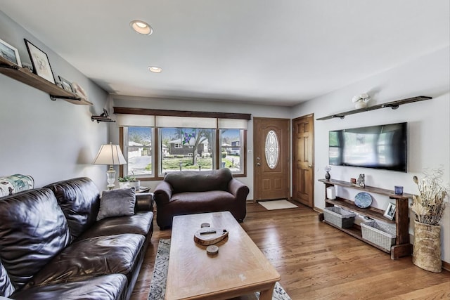 living area with wood finished floors and recessed lighting